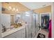Bathroom with a modern glass shower and double vanity with granite countertop at 2016 Bonito Way, Port Charlotte, FL 33953