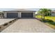 Long paved driveway leading to a two-car garage with well-maintained landscaping at 2016 Bonito Way, Port Charlotte, FL 33953