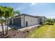 Charming home with a two-car garage, manicured lawn, and lush tropical landscaping at 2016 Bonito Way, Port Charlotte, FL 33953
