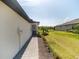 Charming home exterior showcasing a paver walkway, landscaping, and well-kept lawn at 2016 Bonito Way, Port Charlotte, FL 33953