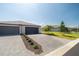 Well-maintained home featuring a two-car garage and manicured landscaping at 2016 Bonito Way, Port Charlotte, FL 33953