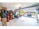 Well-lit garage space with organizational storage, plus a peek at the exterior and the neighborhood at 2016 Bonito Way, Port Charlotte, FL 33953