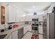 Bright kitchen with stainless steel appliances and white cabinets, offering both style and functionality at 2016 Bonito Way, Port Charlotte, FL 33953