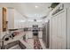 Modern kitchen with stainless steel appliances, granite countertops, and sleek white cabinetry at 2016 Bonito Way, Port Charlotte, FL 33953