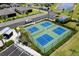 Aerial view of community pickleball courts with blue and green surfaces ready for recreational play at 2016 Bonito Way, Port Charlotte, FL 33953