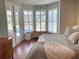Bright bedroom features a bay window, plantation shutters, and wood floors, creating a relaxing retreat at 2149 Muskogee Trl, Nokomis, FL 34275