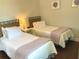 Comfortable guest bedroom featuring twin beds with cozy bedding, and a shared nightstand at 2149 Muskogee Trl, Nokomis, FL 34275