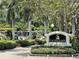 The Calusa Lakes entrance sign with waterfall feature surrounded by lush landscaping and vibrant flowers at 2149 Muskogee Trl, Nokomis, FL 34275