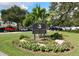 The Calusa Lakes Golf Club community sign surrounded by vibrant flowers and lush landscaping at 2149 Muskogee Trl, Nokomis, FL 34275