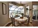 Dining area features views of the pool and backyard, with light neutral decor at 2149 Muskogee Trl, Nokomis, FL 34275