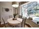 Dining area offers views of the screened pool with neutral decor and modern light fixture at 2149 Muskogee Trl, Nokomis, FL 34275