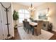 Cozy dining room featuring a chandelier, neutral decor, and a large window for natural light at 2149 Muskogee Trl, Nokomis, FL 34275