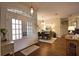 Inviting foyer with hardwood floors, a view of the dining area, and double glass front doors at 2149 Muskogee Trl, Nokomis, FL 34275