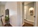 Bright hallway with wood accent wall leading to other rooms at 2149 Muskogee Trl, Nokomis, FL 34275