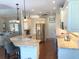 Open kitchen with granite counters, stainless steel appliances, and a breakfast bar overlooking the living area at 2149 Muskogee Trl, Nokomis, FL 34275