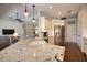 Bright, open kitchen with stainless steel appliances, granite countertops, and hardwood floors at 2149 Muskogee Trl, Nokomis, FL 34275