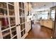 Gourmet kitchen with stainless appliances, granite countertops, wood floors, and glass-door pantry at 2149 Muskogee Trl, Nokomis, FL 34275