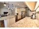 Bright kitchen features stainless appliances, stone countertops, and open layout to living space at 2149 Muskogee Trl, Nokomis, FL 34275