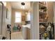 Functional laundry room with washer, dryer, storage cabinets, and shelves for supplies at 2149 Muskogee Trl, Nokomis, FL 34275