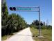 View of the Legacy Trail with a light signal highlighting the trail entrance at 2149 Muskogee Trl, Nokomis, FL 34275