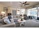 Comfortable living area with a large sectional sofa, a ceiling fan, and access to the lanai at 2149 Muskogee Trl, Nokomis, FL 34275