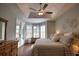 Main bedroom with tray ceiling and private access to the pool area at 2149 Muskogee Trl, Nokomis, FL 34275