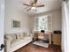 Bright office space featuring a ceiling fan, hardwood floors, and a cozy sofa and desk setup at 2149 Muskogee Trl, Nokomis, FL 34275