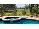 Enjoy serene golf course views from this backyard pool and spa with lush landscaping, perfect for outdoor relaxation at 2149 Muskogee Trl, Nokomis, FL 34275