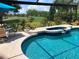 Inviting screened-in pool and spa area features a serene golf course view at 2149 Muskogee Trl, Nokomis, FL 34275