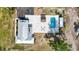 Contemporary home featuring a pool, outdoor seating, pristine rooftop, and a well-manicured yard, captured from above at 2255 61St St, Sarasota, FL 34243