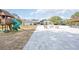 Backyard featuring a pool, tiki bar, playhouse, and a fire pit with rocking chairs at 2255 61St St, Sarasota, FL 34243