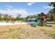 Large backyard with a playset, pool, cabana, separate cottage, and plenty of room to run and play at 2255 61St St, Sarasota, FL 34243