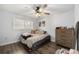 Cozy bedroom featuring wood-look floors, ceiling fan, large windows, and a comfortable bed at 2255 61St St, Sarasota, FL 34243