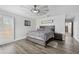 This bedroom features a large bed, wood-look floors, a ceiling fan, and neutral paint colors at 2255 61St St, Sarasota, FL 34243