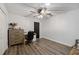 Bedroom featuring wood-look floors, neutral walls, ceiling fan and study area at 2255 61St St, Sarasota, FL 34243