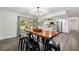 Bright dining area with wood table and black chairs, leading to modern kitchen and outdoor patio at 2255 61St St, Sarasota, FL 34243