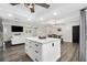 Open-concept kitchen featuring a large island with seating, pendant lighting, and seamlessly connects to the living area at 2255 61St St, Sarasota, FL 34243