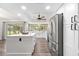 Beautiful kitchen featuring stainless steel appliances, large center island, farmhouse sink and ample natural light at 2255 61St St, Sarasota, FL 34243