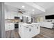 Modern kitchen featuring white cabinetry, stainless steel appliances, marble countertops, and a central island at 2255 61St St, Sarasota, FL 34243
