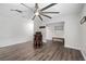 Living space with wood-look flooring, shiplap wall, and massage chair at 2255 61St St, Sarasota, FL 34243