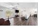 Bright living room with plantation shutters, vinyl plank flooring, and ample natural light at 2255 61St St, Sarasota, FL 34243