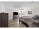 Inviting main bedroom with neutral tones, wood-look floors, a ceiling fan, and a large dresser at 2255 61St St, Sarasota, FL 34243