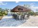 Outdoor bar with a thatched roof, seating for twelve, and a view of the pool at 2255 61St St, Sarasota, FL 34243