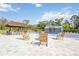Charming backyard patio with an outdoor tiki bar, comfortable seating and a beautiful pool at 2255 61St St, Sarasota, FL 34243