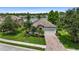 An aerial view of a lovely home with pristine landscaping, a brick driveway and a lake in the backyard at 2334 50Th Street E Cir, Palmetto, FL 34221