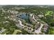Expansive aerial view showcasing a residential area with lush green surroundings and a serene lake at 2334 50Th Street E Cir, Palmetto, FL 34221