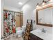 Bright bathroom with wood-look flooring, single sink vanity, and tub-shower combo at 2334 50Th Street E Cir, Palmetto, FL 34221