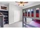 Bright bedroom featuring a bunk bed, ceiling fan, plush carpet, and closet for optimal storage at 2334 50Th Street E Cir, Palmetto, FL 34221