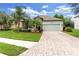 Beautiful single-story home featuring a two-car garage, stone accents, and lush landscaping at 2334 50Th Street E Cir, Palmetto, FL 34221