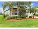 Charming house featuring stone accents, well-maintained landscaping, and a lush green lawn at 2334 50Th Street E Cir, Palmetto, FL 34221